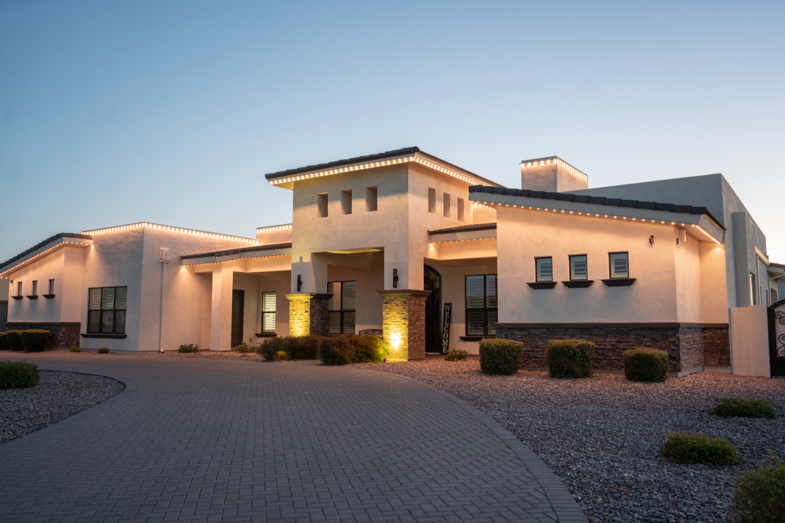 Home at night with warm roofline lighting on